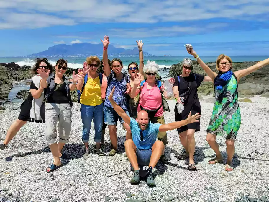 Wes and a happy tour group standing along Blouberg Beach