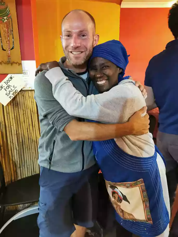 Sheila and Wes smiling outside Le Lapa community venue
