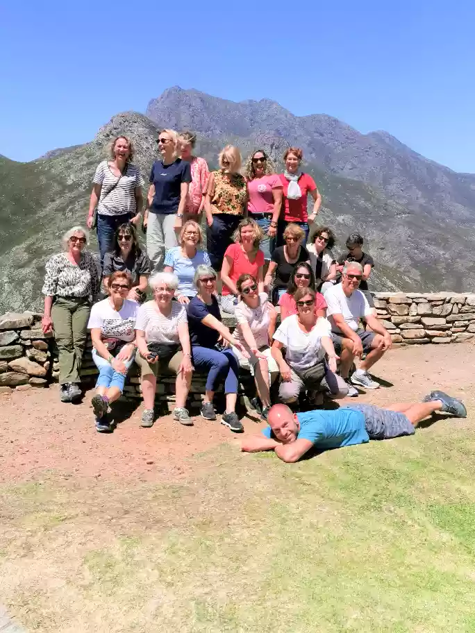 Group checking out panoramic high-impact views along dry interior mountain paths