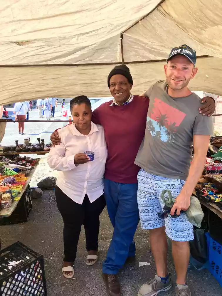 Wes interacting with local small business owners inside a Langa market space