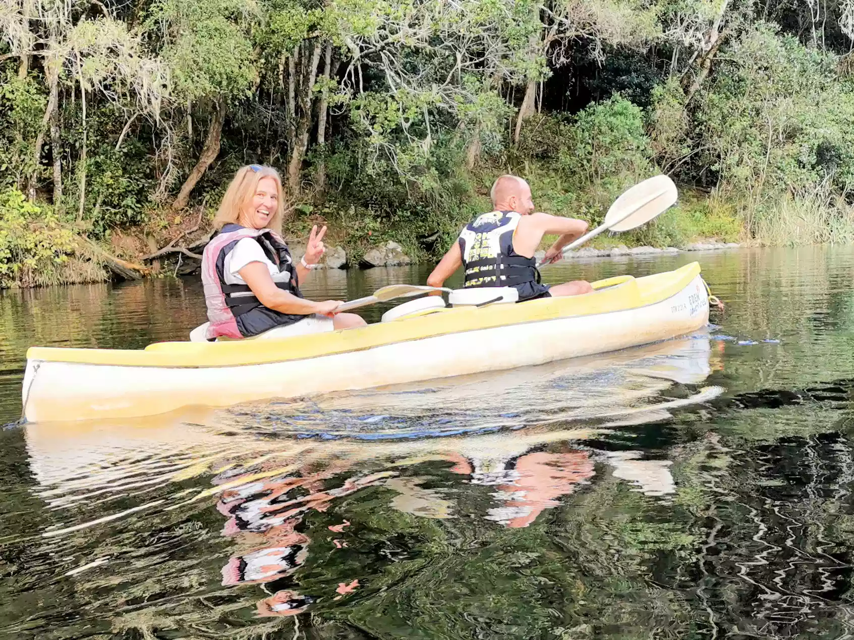 Wes and travelers row-boating along the calm Wilderness river channels